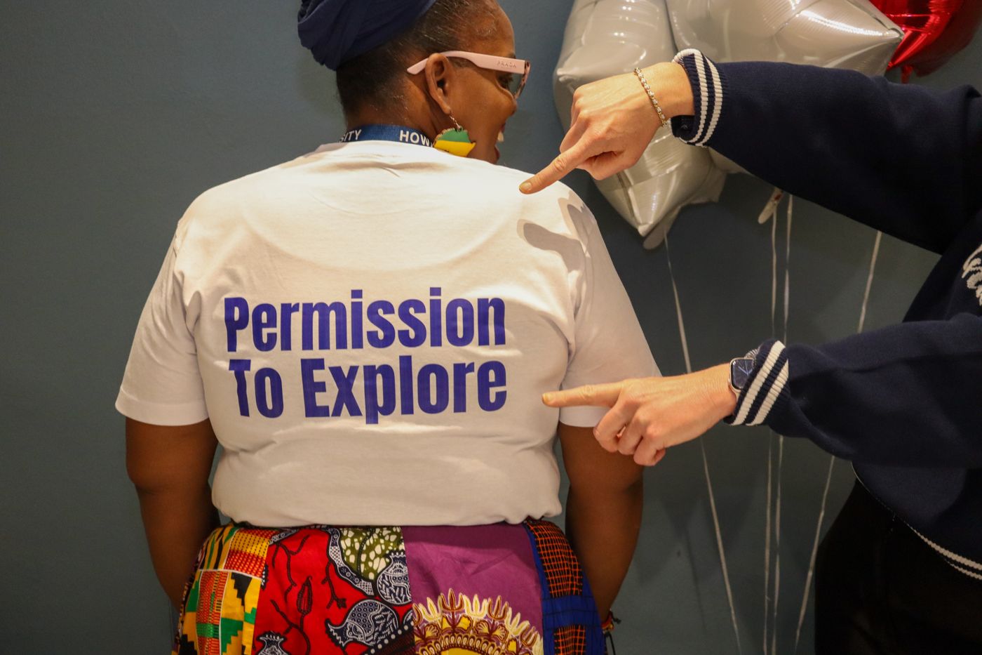 Permission to Explore — the week's tagline worn on a team shirt